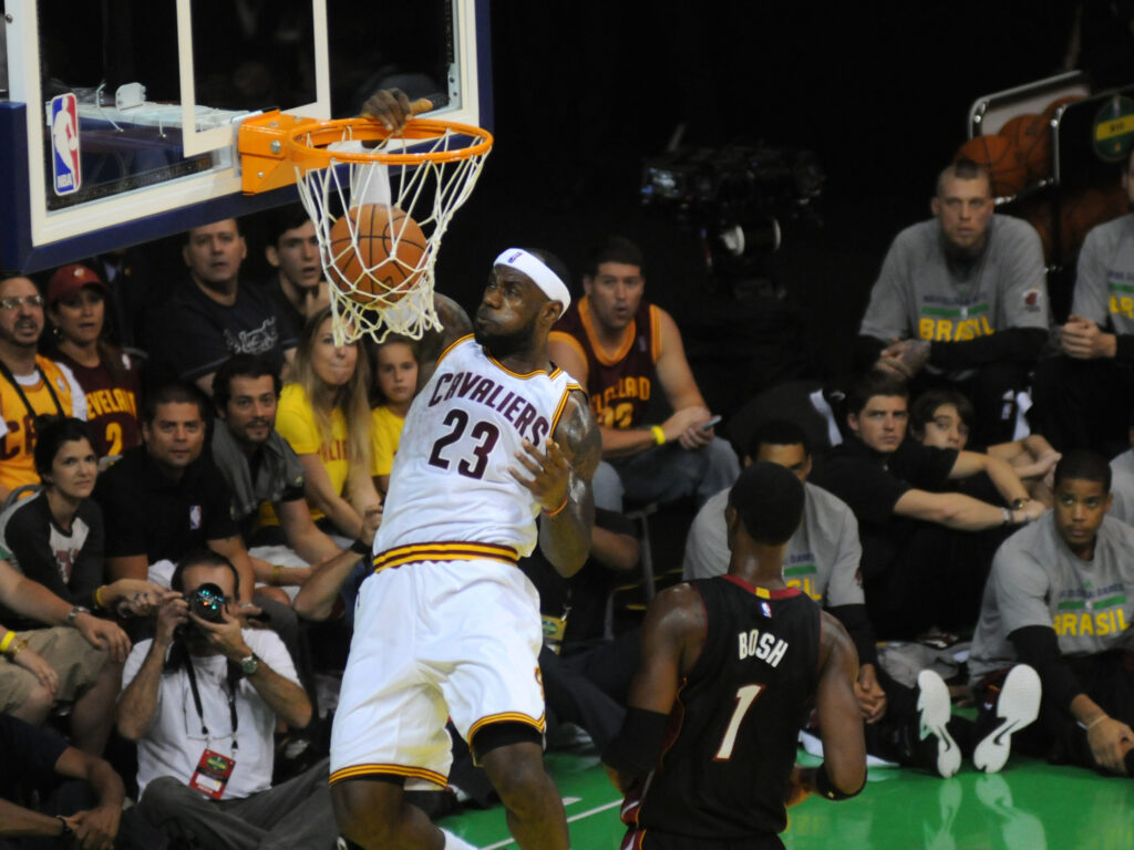 Basketball player makes a dunk during an NBA game.