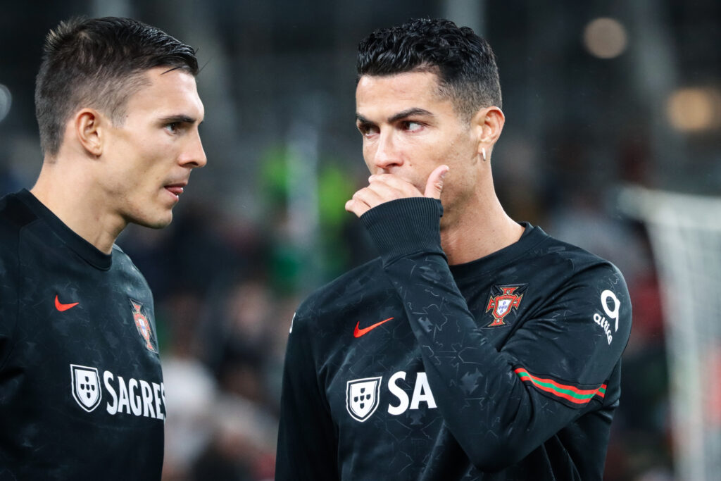 Two footballers talking on the pitch