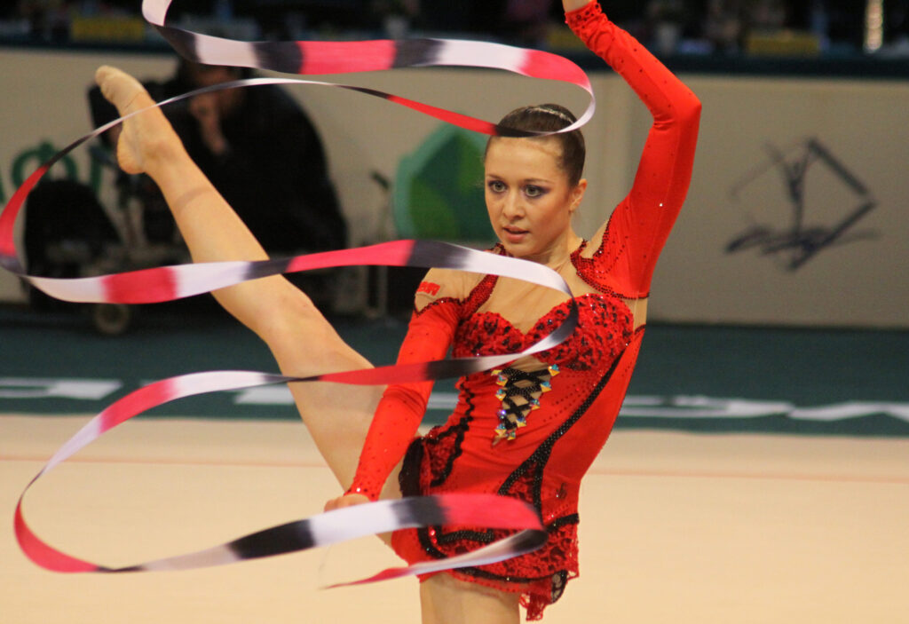 Gymnastics with ribbon, red uniform